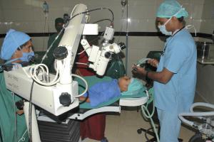 A young African child being examined with one of the Grange's 'Optyse' ophthalmoscopes